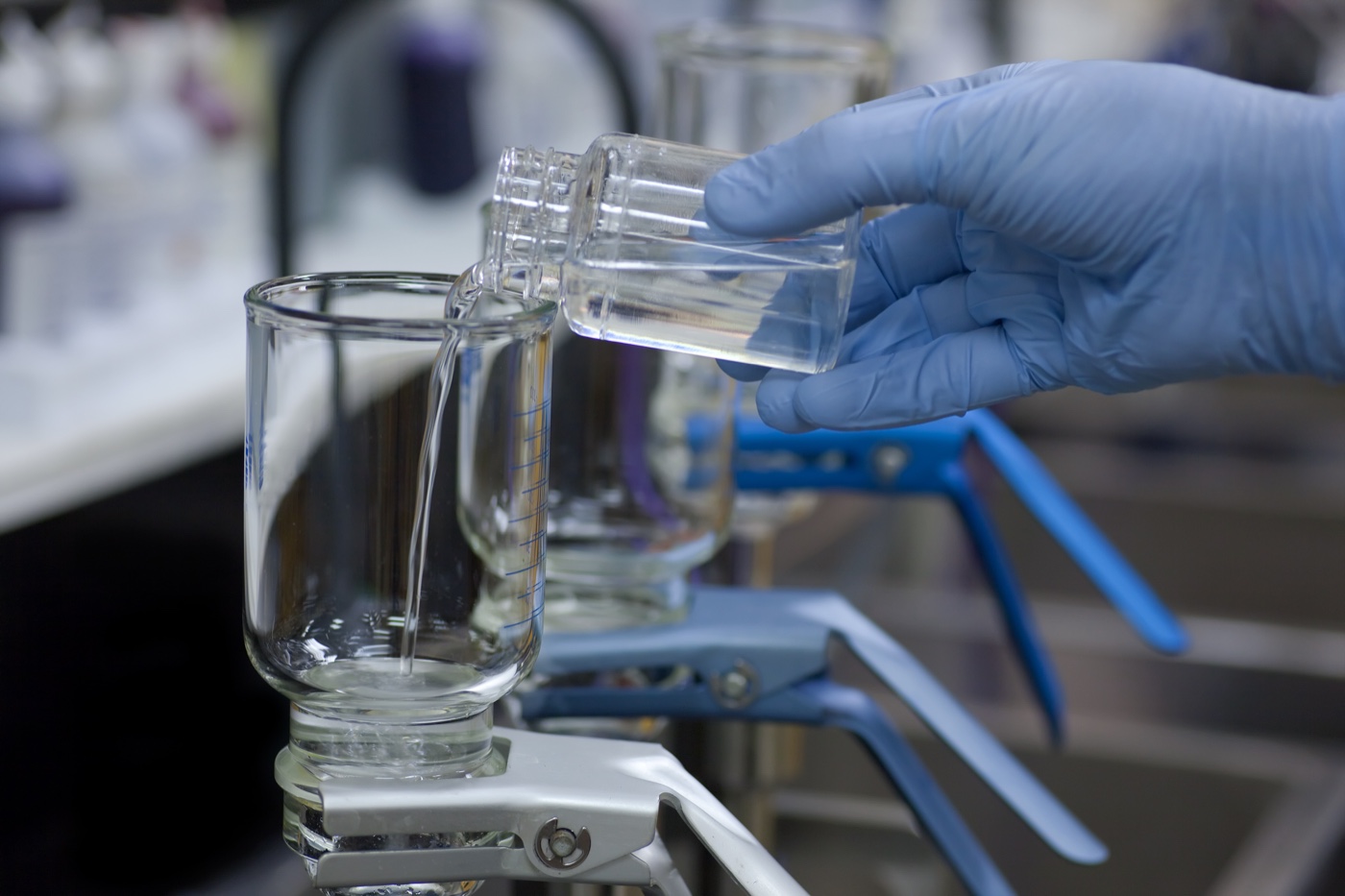 Water sample being poured into a laboratory filtration unit
